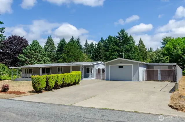 Detached one car garage has additional shed space for all your tools and toys. The oversized paved driveway provides loads of extra parking space for RV or boat.