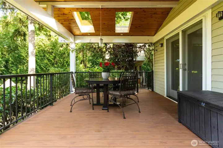 The expansive deck, accessible from the kitchen and dining room, offers an inviting space for lively outdoor gatherings