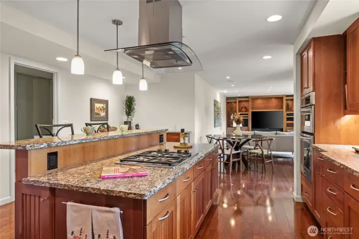 Chef’s kitchen with granite island, eating bar, and gas cooktop