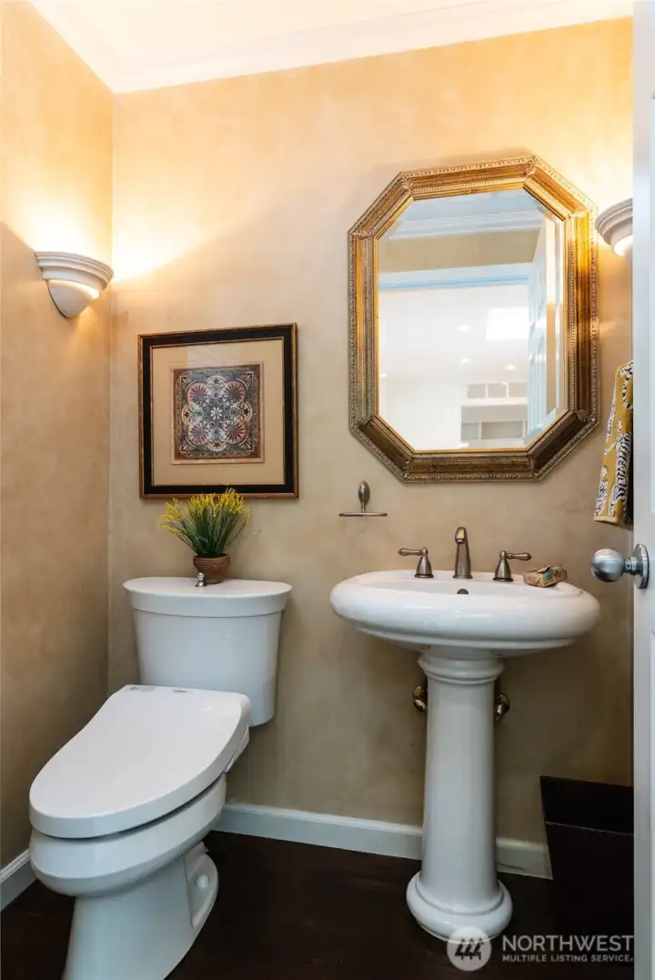 Main floor powder room with a heated TOTO Washlet toilet, pedestal sink, and Venetian-style painted walls