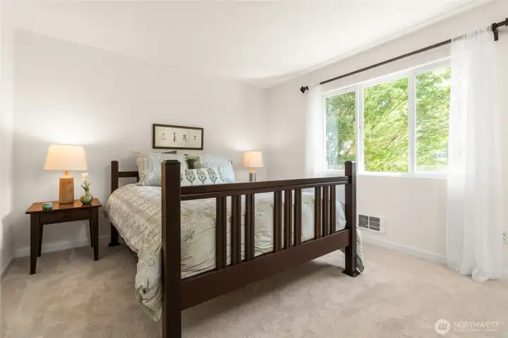 Nicely sized secondary bedroom features a large window facing the front yard, providing neighborhood views