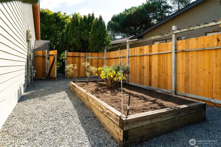 Raised flower beds on south side of home offer the ideal location for an urban garden