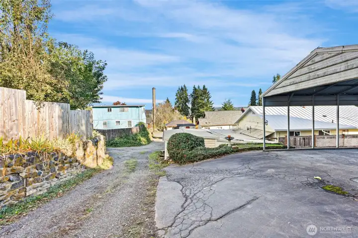 Back alley with entrance to driveway & carport