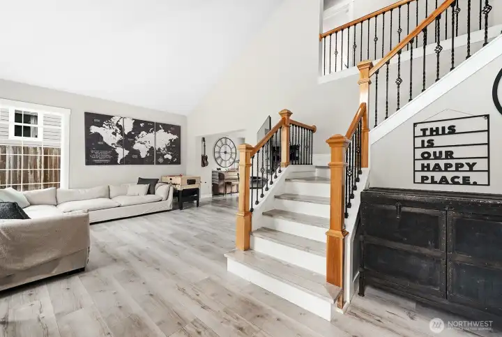 Open rail staircase showing the hardsurface flooring on the stairs and throughout.