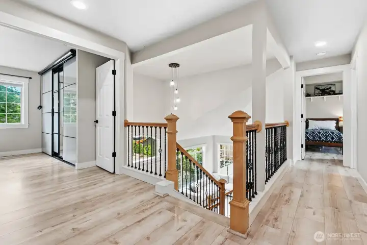 Upstairs landing with had surface flooring and connectivity to vaulted ceiling living room.