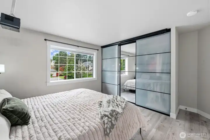 Primary suite has 2 closets. The one pictured here has closet organizer and projector above it.