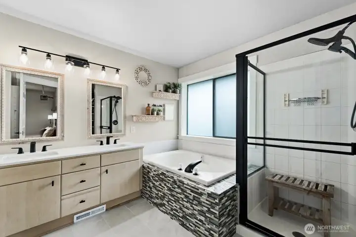 Primary bathroom with double sinks and hard surface countertops.