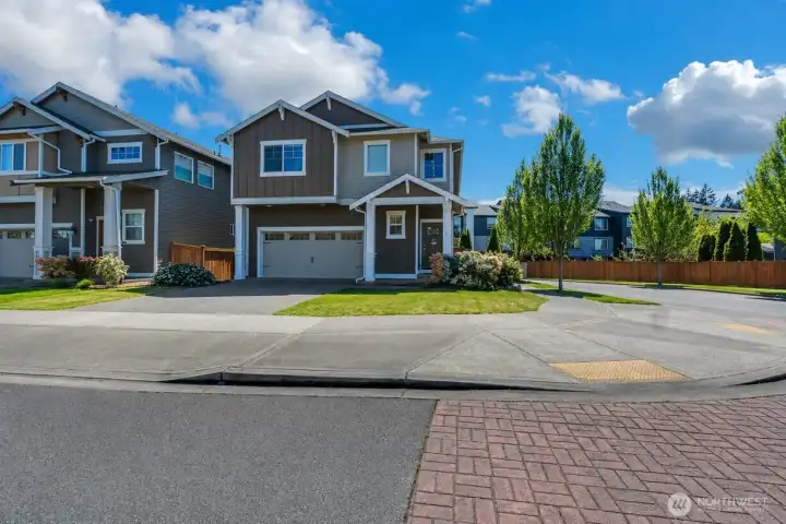 Inviting corner lot setting with additional space for parking.