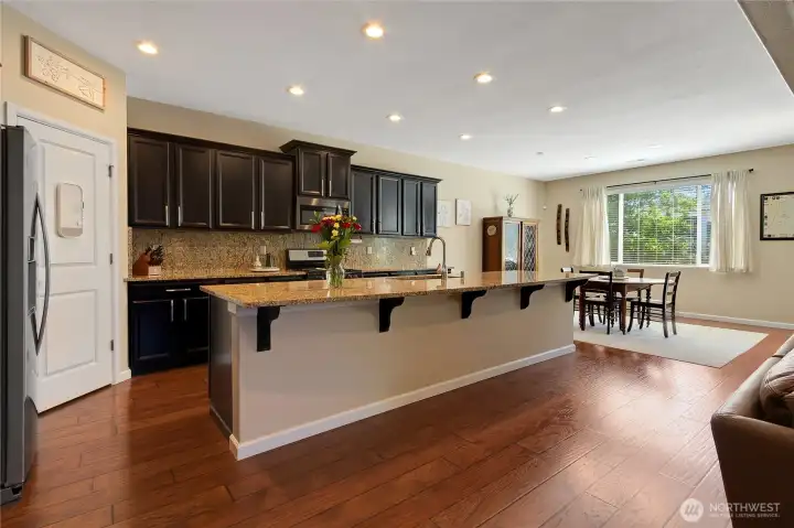Kitchen is anchored around the large granite countertop island.