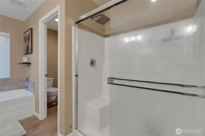 Full bathroom with stand up shower and bath tub.