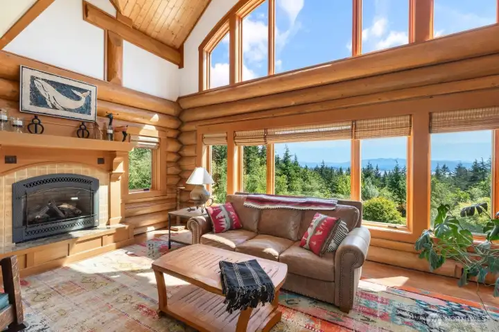Living room has a propane fireplace for cozy winter evenings, and an expansive two story window wall looking out to the incredible view. Living room has a propane fireplace for cozy winter evenings, and an expansive two story window wall looking out to the incredible view.