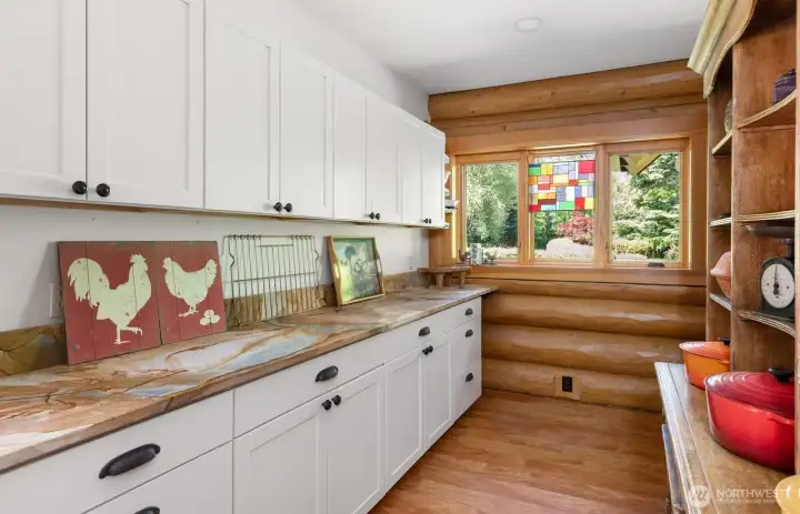 The pantry is huge and has this gorgeous countertop of natural stone Not pictured is a second refrigerator that will convey with the home. Views here are out to the meticulous landscaping. The pantry is huge and has this gorgeous countertop of natural stone Not pictured is a second refrigerator that will convey with the home. Views here are out to the meticulous landscaping.