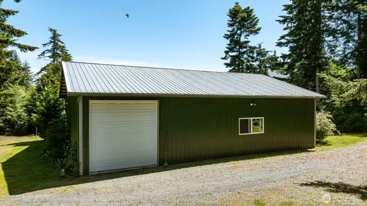 Another view of the shop. Man doors are at either end. Gravel drive here provides access as well as outdoor parking if needed. Another view of the shop. Man doors are at either end. Gravel drive here provides access as well as outdoor parking if needed.