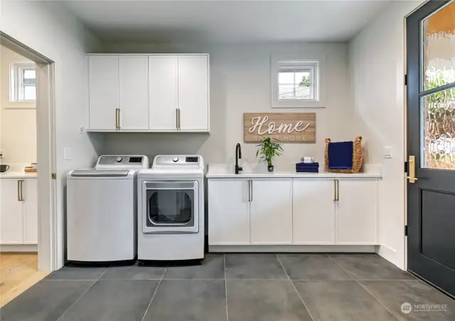 Main floor laundry/mudroom. A second laundry is featured on the 2nd floor, as well as full-size stacking washer/dryer in the ADU.