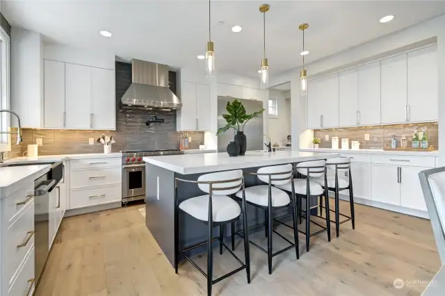 Gourmet kitchen with 2" quartz counters and underlighting.