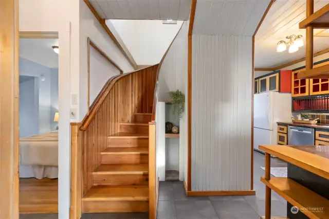 Main floor living! Kitchen to the right, bedroom to the left.  These stairs were hand crafted by the renowned builder and owner.