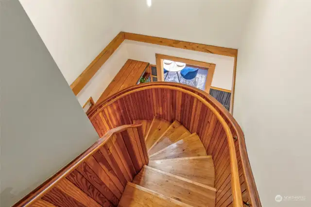 Gorgeous custom stairs made with love. View to the lower "cafe" area. Leads to the upper level.