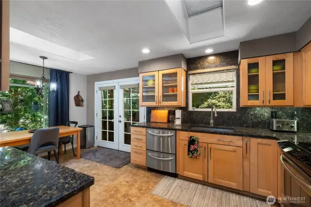 Maple cabinetry. French door opens to your covered deck with a screen.