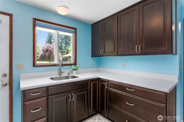 Another sink area with cabinets in the laundry room