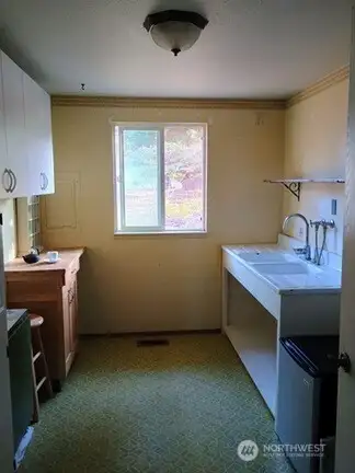 Laundry room converted to a kitchenette.
