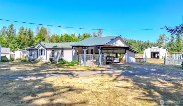 Horse shoe driveway and large carport.