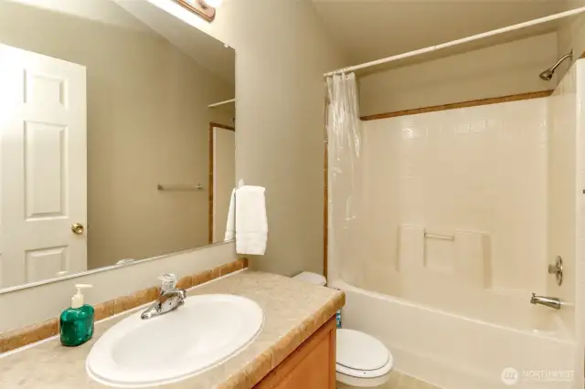 Main full bathroom shared by additional bedrooms on North end of home.