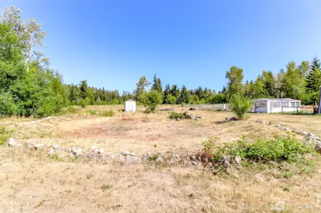 Seasonal pond area that some years has water and some does not. Dry shed that was used for tack shows at the end.