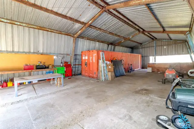 Steel framing and metal roof and sides with concrete floors. Gravel runs in between concrete are former drains for cleaning our barn.