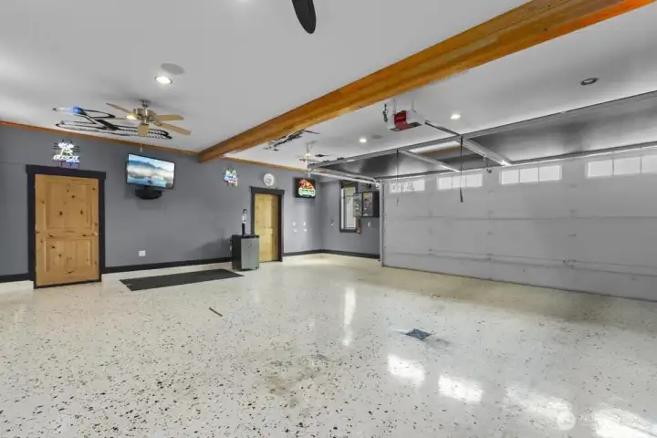 Not your average garage—custom millwork & surround sound.