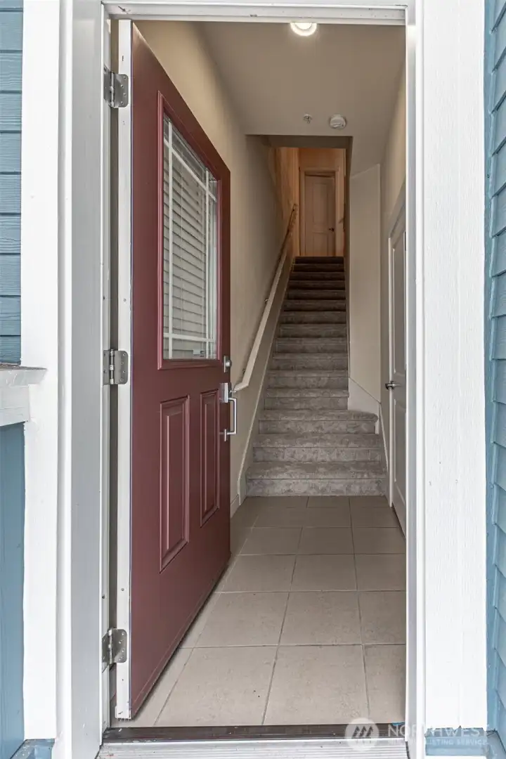 Front door with interior garage access to the right.