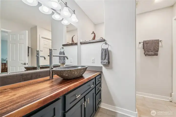 Primary bath is artistid & spacious and would be a great place to wind down at the end of a long day.