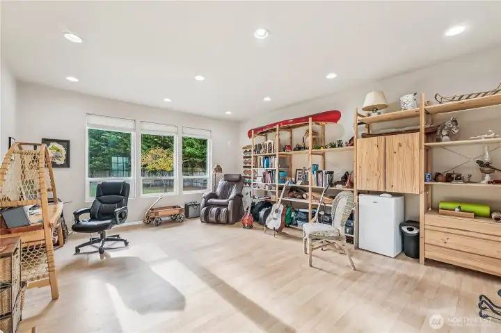 Bonus room has flush mounted lights and large wall of windows.