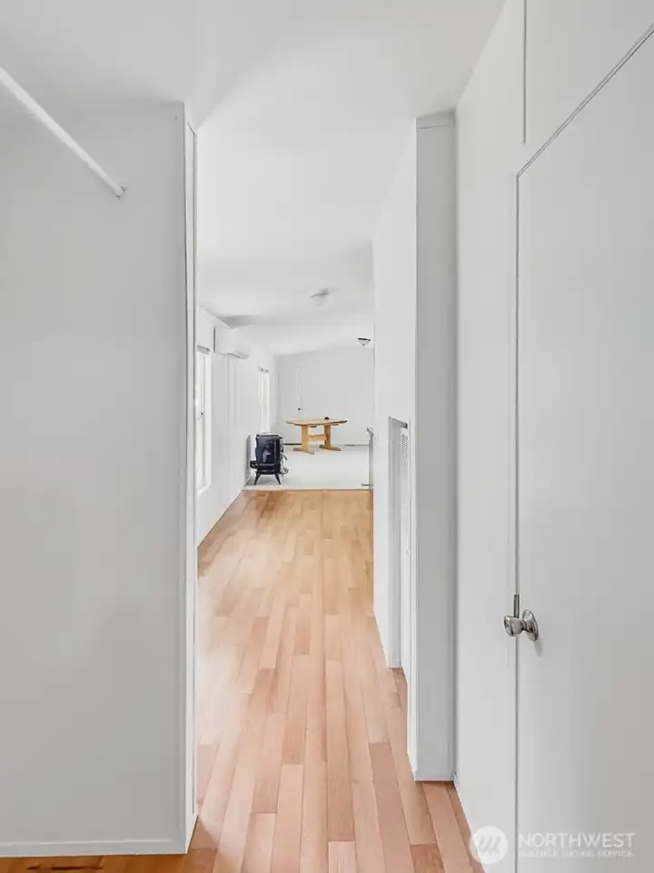 View from laundry and primary into the kitchen & living room.