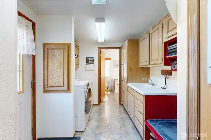 large utility room with storage and access from primary BR