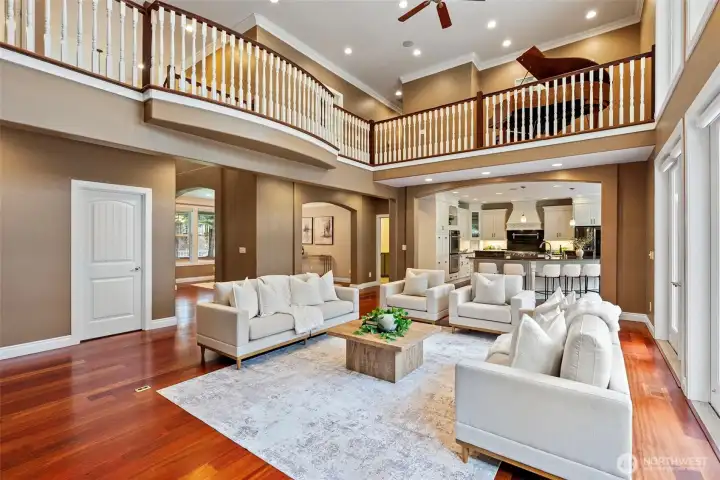 Open concept living room with vaulted ceilings and dual ceiling fans.