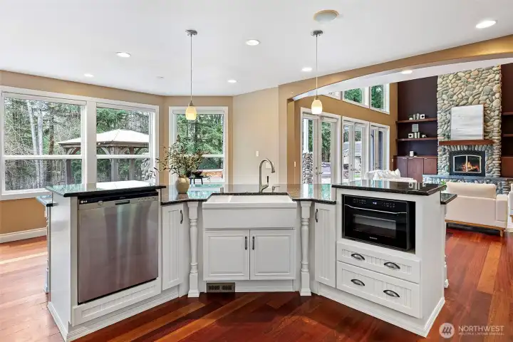 Chef's kitchen with seating for eight, farmhouse sink and built in microwave.  Four sets of French doors open to the back patio... ideal for summer entertaining in a quintessential Pacific Northwest setting.