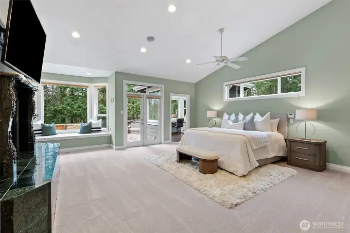 Primary bedroom on the main level, with bay windows, French doors that lead to the back patio, gas fireplace and enormous office with storage.