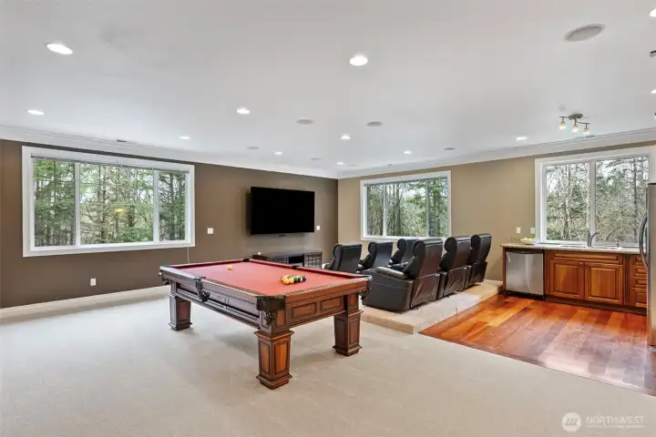 Media/rec room equipped with a kitchen,  theater seating, and a powder room (second level).
