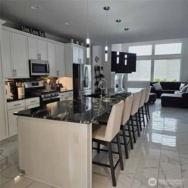 Kitchen with a 15 feet long countertop fits easy 5 to 6 stools.