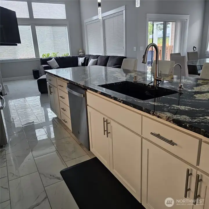 Open concept, kitchen leads to the living room and the dining room to the right.