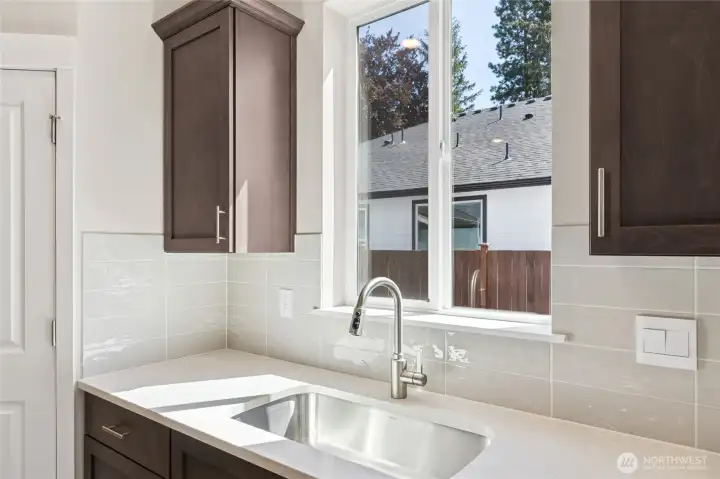 Window above kitchen sink to look out to the Mountains and large yard. Soft close drawers throughout home. Photo is representational. Actual home is under construction and finishes, and paint colors may vary. See site agent for details.