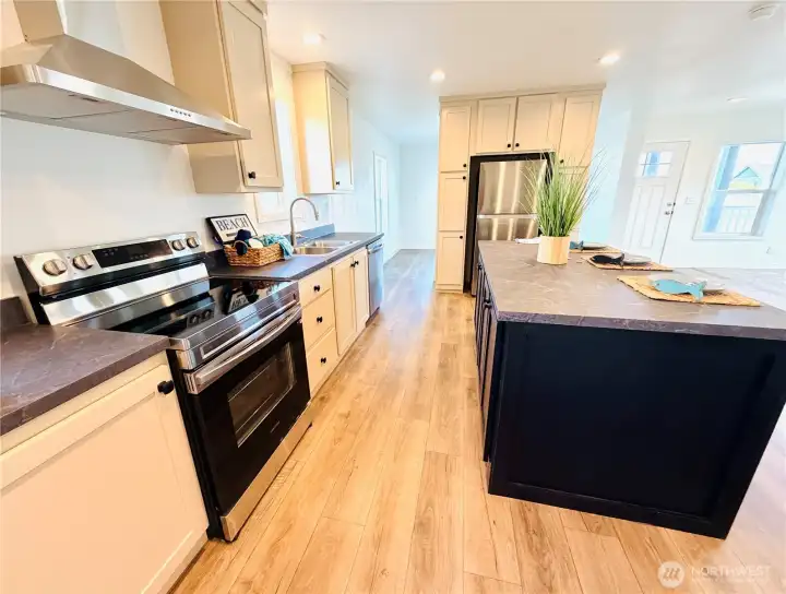 Lots of countertop space for food prep and full height upper cabinets.
