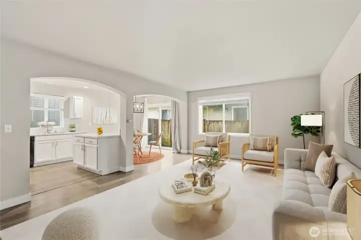 Step into to this inviting great room with charming arched doorways and laminate hardwood flooring that grace the open & airy living spaces. (Virtual Staging)