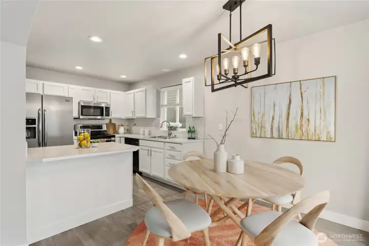 The open kitchen and dining space create an effortless flow between the two spaces, great for ease of serving up delish meals right from the stove top to the dinner table. (Virtual Staging)
