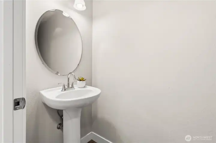 Discreetly tucked around the corner from the great room and on your way to the garage is the main floor powder room.
