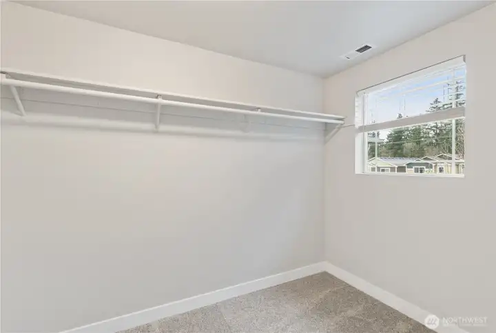 A large picture window allows all the natural light to pour through the expansive walk-in closet.