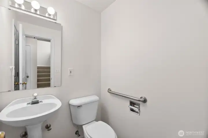 main floor 1/2 bath.  Storage behind door