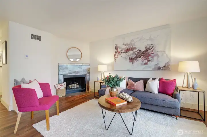 The living room is graced with a cozy fireplace.  Newer LVP flooring is featured throughout.