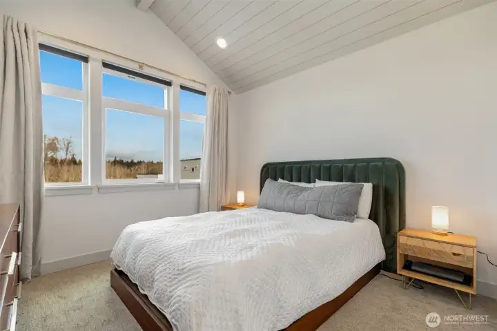 Oversized primary suite with vaulted ship-lapped ceilings & territorial views