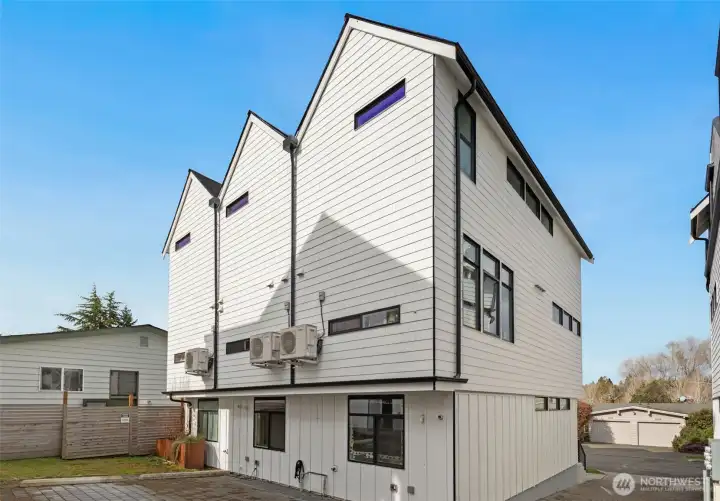 Rear of building with private parking & EV charger